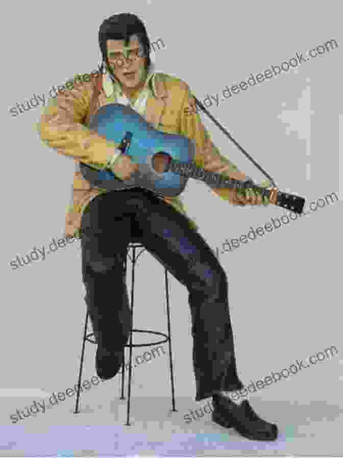 Elvis Presley Sitting On A Stool Playing Guitar In Kentucky Rain 25 Best Songs Of Elvis Presley
